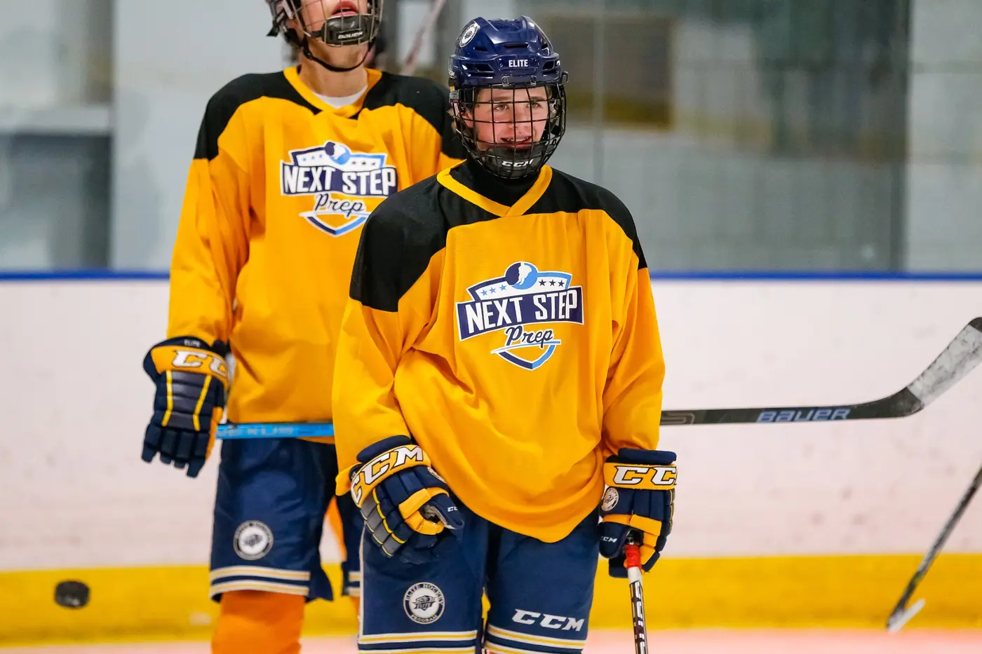 Next Step Prep players wearing gold hockey practice jerseys