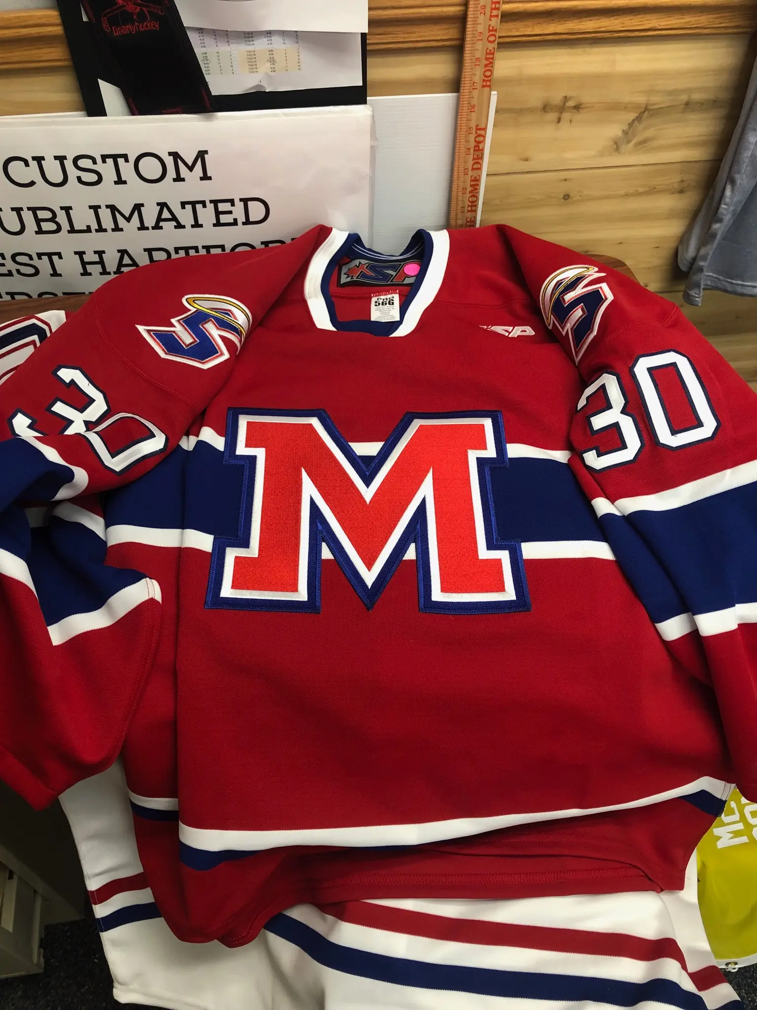 Finished Mount St. Charles Academy red hockey jersey