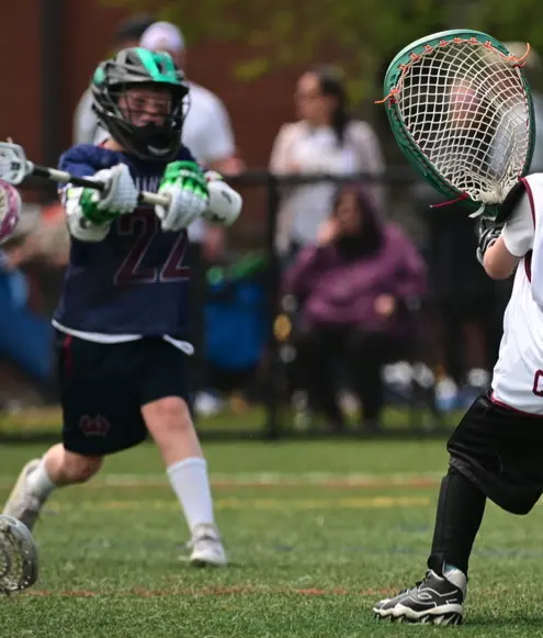 Wallingford lacrosse player wearing the navy blue game uniform